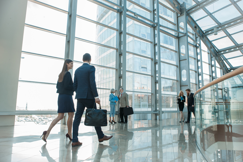 Business,People,Walking,In,Modern,Glass,Office,Building